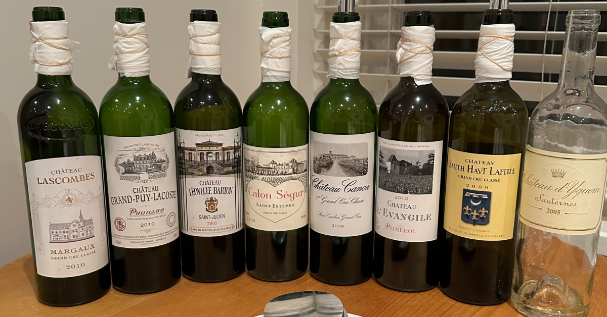 A series of very expensive French wines all lined up in a row